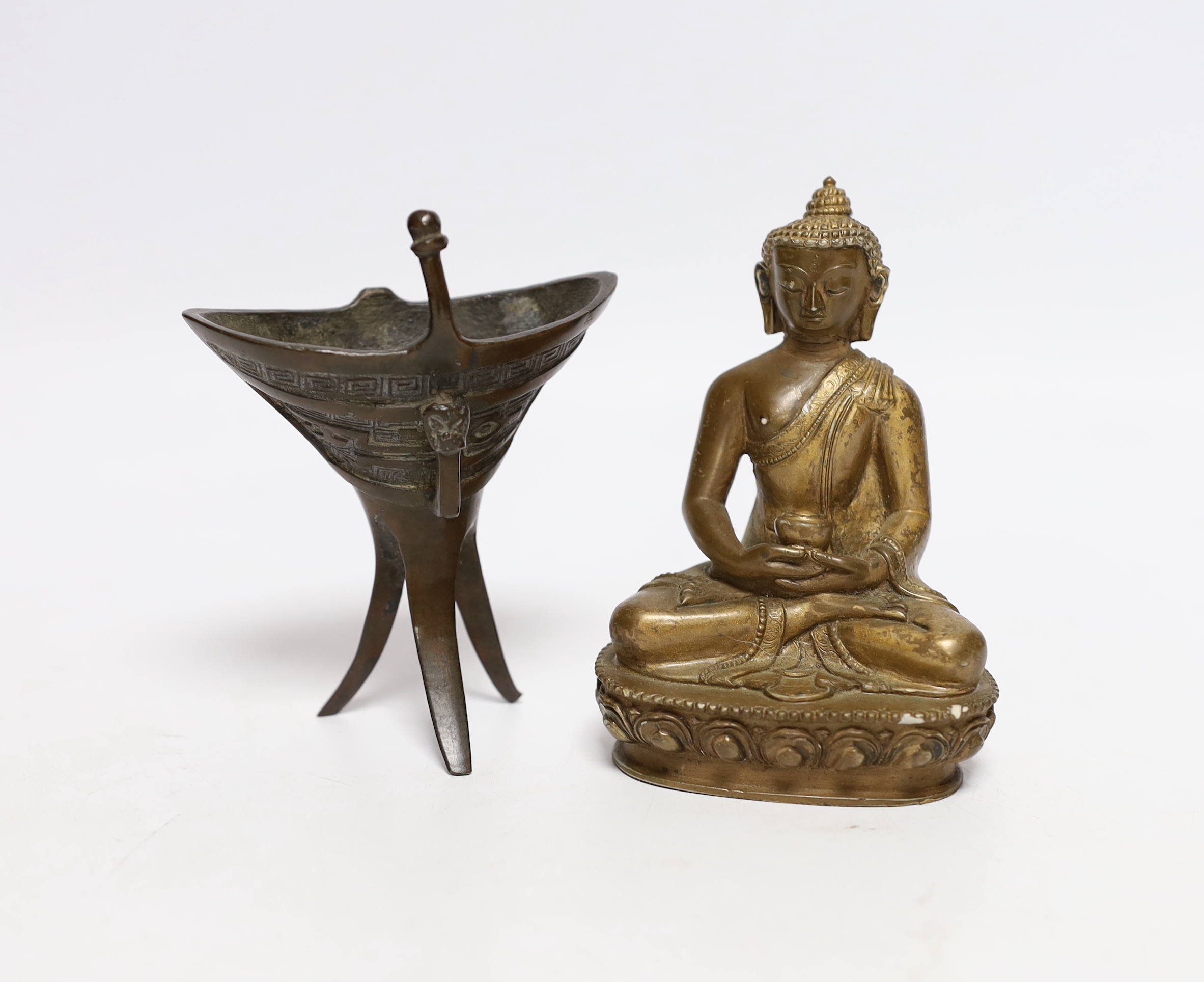 A Chinese archaistic bronze jue vessel and a bronzed plaster figure of Buddha, tallest 11.5cm